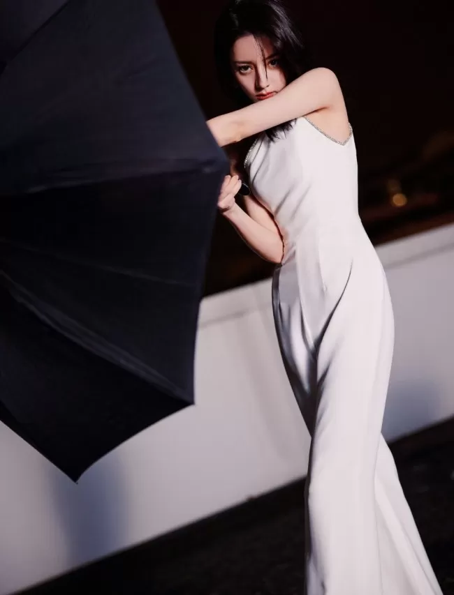 热巴穿斜肩连体裤撑黑伞 眼神霸气酷飒十足