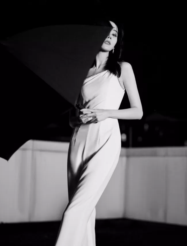 热巴穿斜肩连体裤撑黑伞 眼神霸气酷飒十足